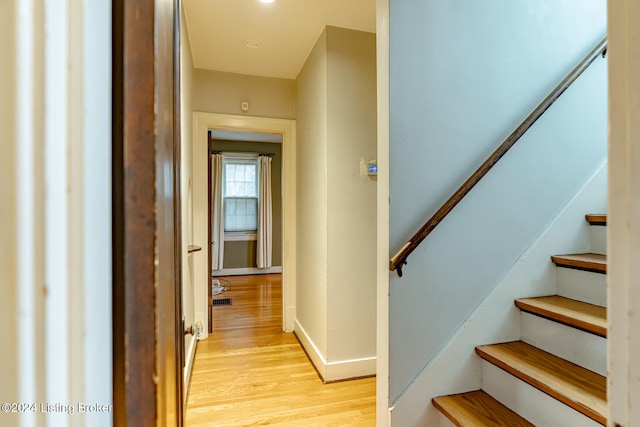 staircase with hardwood / wood-style floors