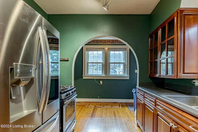 kitchen featuring sink, light hardwood / wood-style floors, and appliances with stainless steel finishes