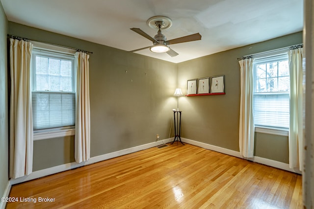 empty room featuring ceiling fan and light hardwood / wood-style floors