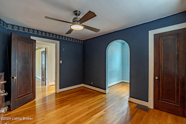 unfurnished bedroom with ceiling fan and light wood-type flooring