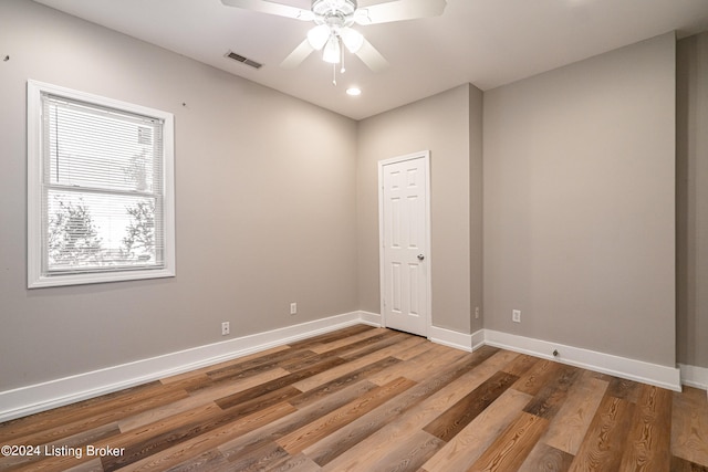 spare room featuring hardwood / wood-style floors and ceiling fan