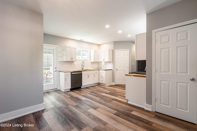 kitchen featuring dishwasher, white cabinets, sink, dark hardwood / wood-style floors, and decorative backsplash