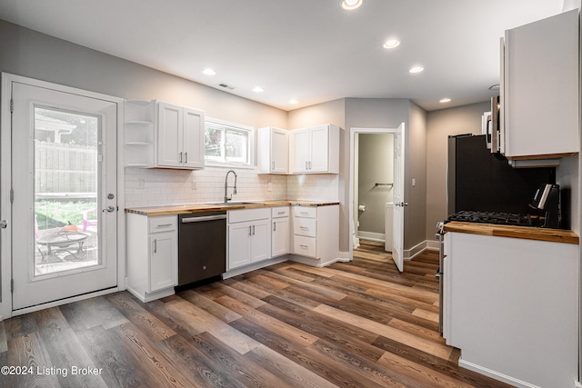 kitchen featuring stainless steel dishwasher, dark wood-type flooring, sink, white cabinetry, and butcher block counters