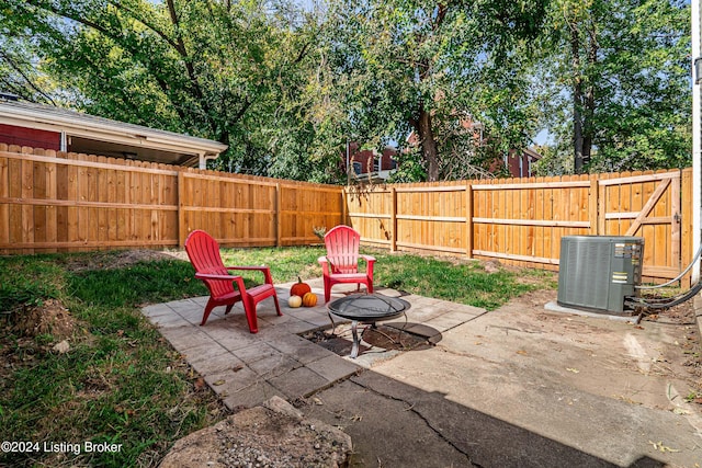 view of patio featuring central AC and a fire pit