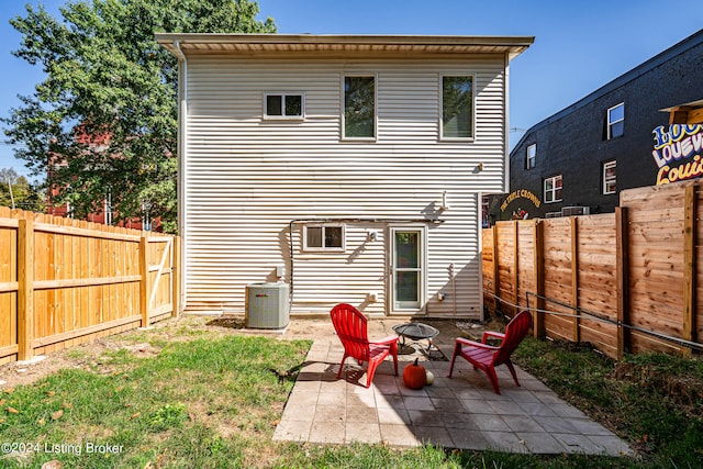 back of house featuring a patio, central AC unit, and an outdoor fire pit