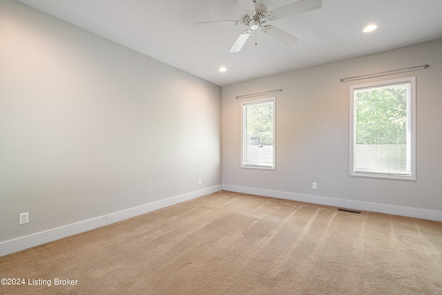 empty room featuring light carpet and ceiling fan