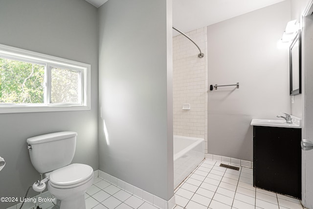 full bathroom with tile patterned flooring, vanity, tiled shower / bath combo, and toilet