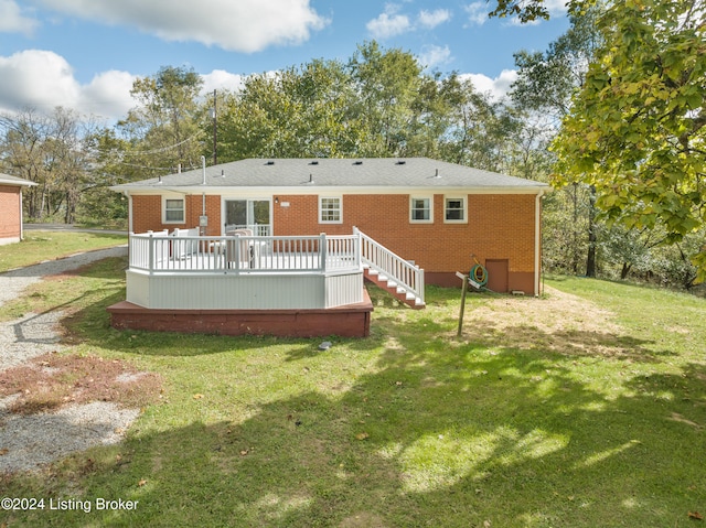 back of property with a lawn and a deck