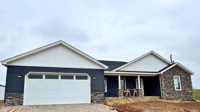 craftsman-style home featuring covered porch and a garage