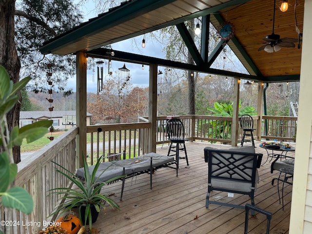 wooden terrace featuring ceiling fan