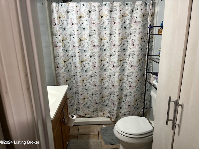 bathroom featuring a shower with curtain, vanity, toilet, and tile patterned floors