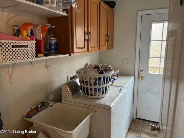 laundry room with light tile patterned flooring, cabinet space, a sink, and separate washer and dryer