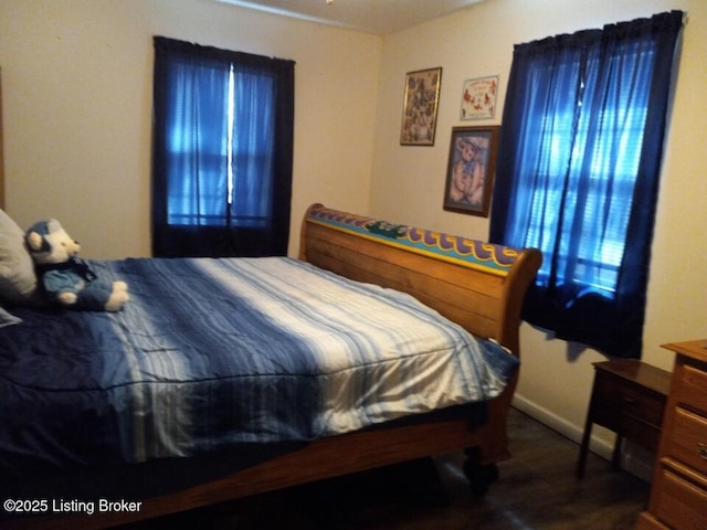 bedroom with dark wood-type flooring