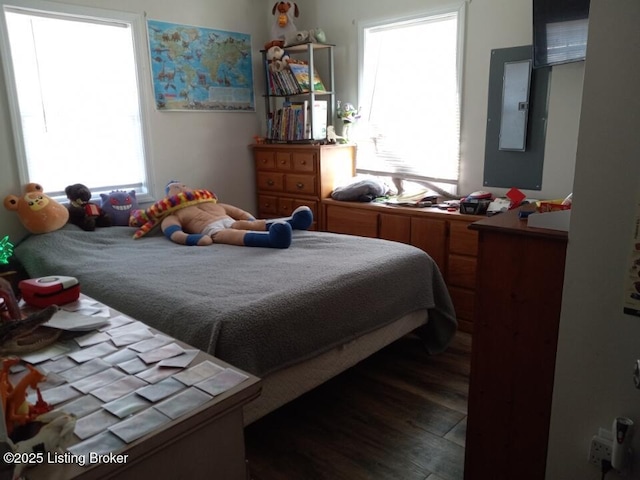 bedroom featuring electric panel and wood finished floors