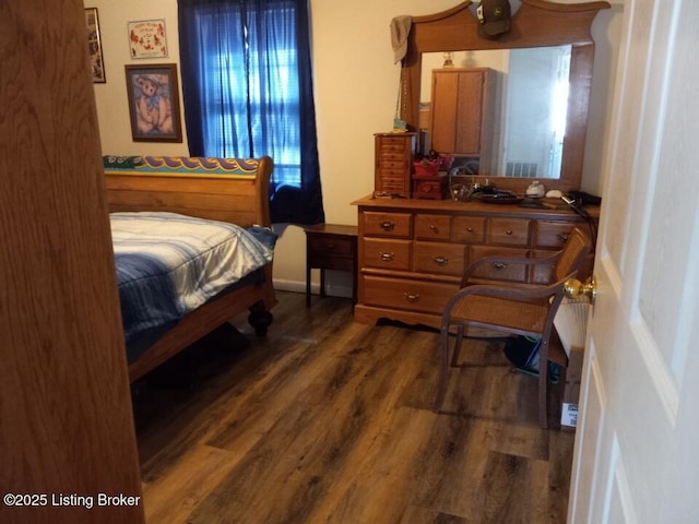 bedroom with dark wood finished floors