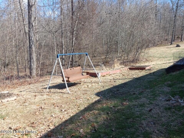 view of play area with a wooded view