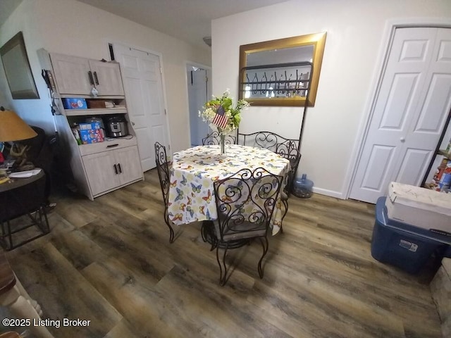 dining space with dark wood-style floors and baseboards