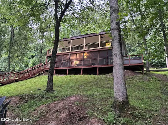 rear view of house featuring a yard