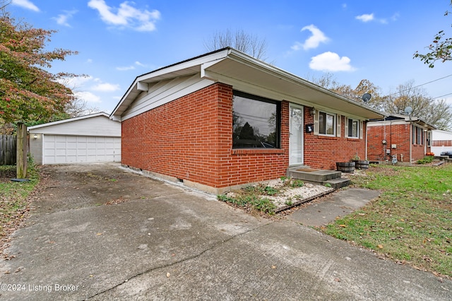 view of front of house featuring a garage and an outbuilding