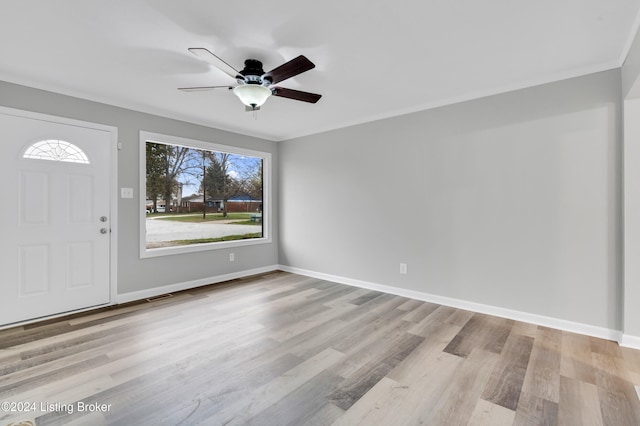 foyer featuring light wood-type flooring, ceiling fan, and a healthy amount of sunlight