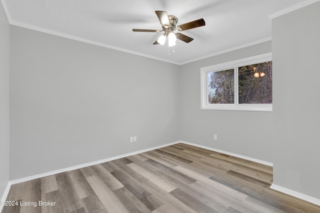 spare room featuring ceiling fan, light wood-type flooring, and ornamental molding