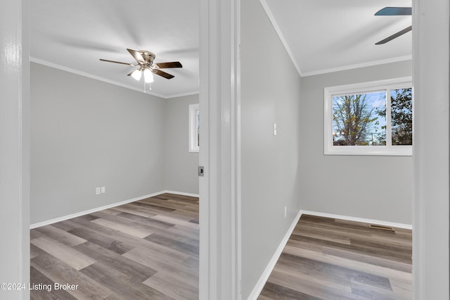 unfurnished room with wood-type flooring, plenty of natural light, and ornamental molding