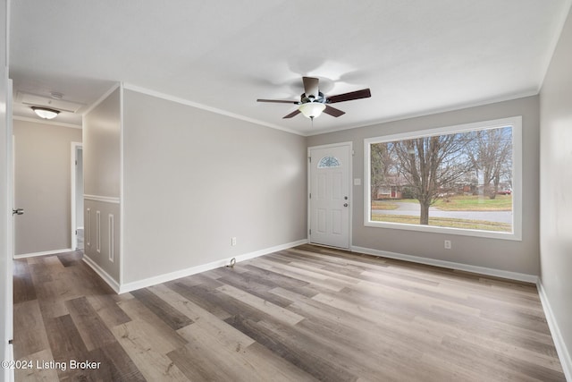 unfurnished room featuring light hardwood / wood-style floors, ceiling fan, and ornamental molding