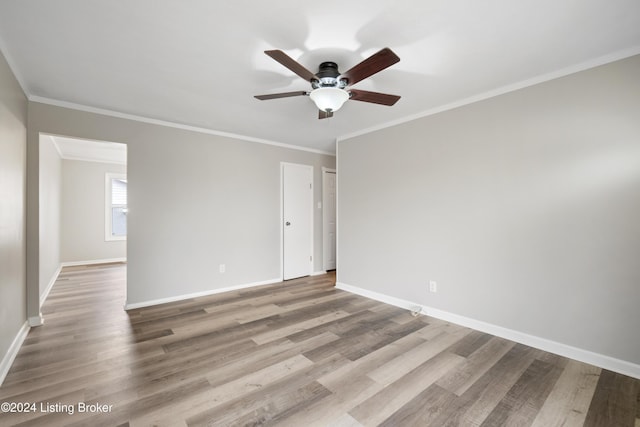 empty room featuring light hardwood / wood-style flooring, ceiling fan, and crown molding