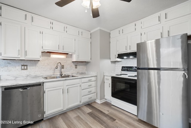 kitchen featuring appliances with stainless steel finishes, light wood-type flooring, ceiling fan, sink, and white cabinetry