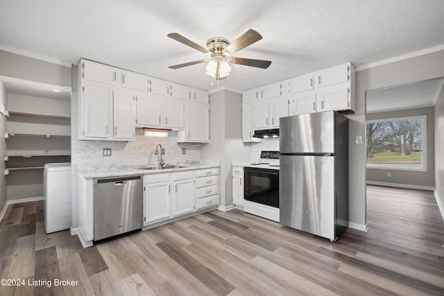 kitchen featuring backsplash, white cabinets, sink, ceiling fan, and stainless steel appliances