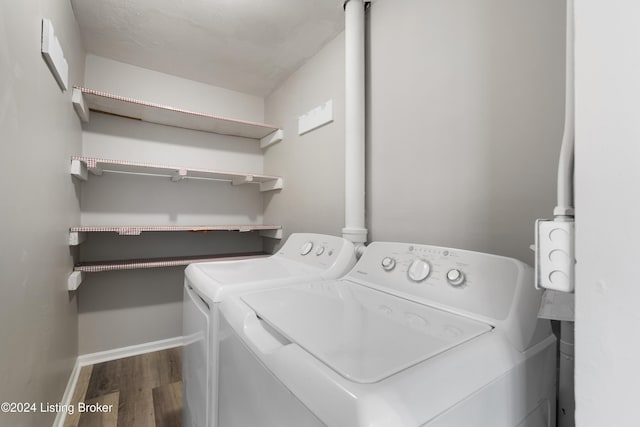 laundry area featuring hardwood / wood-style floors and washer and clothes dryer