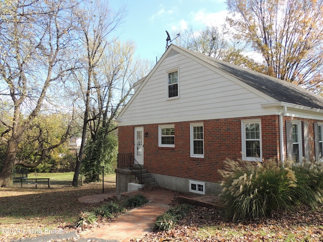 view of property exterior with brick siding