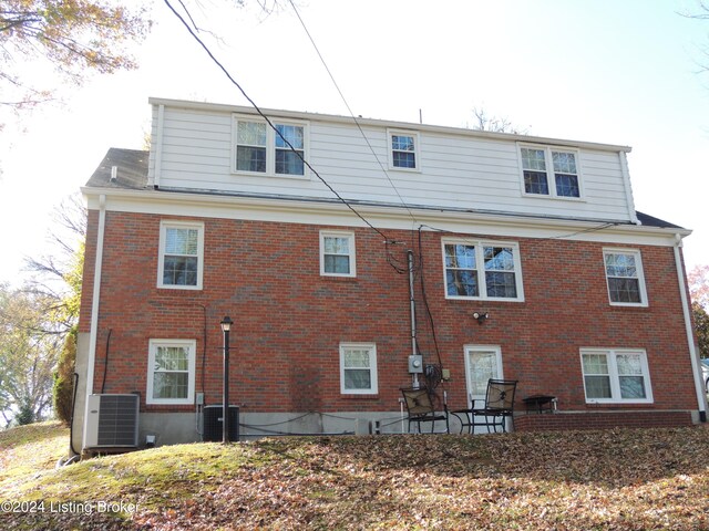 back of house with central AC unit