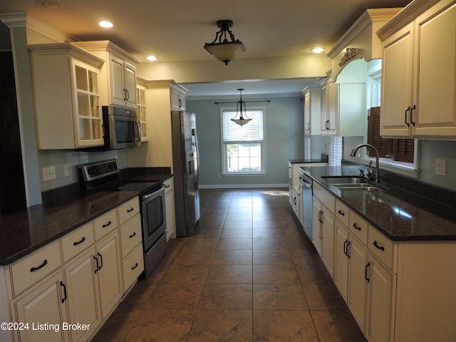 kitchen featuring sink, ornamental molding, hanging light fixtures, and appliances with stainless steel finishes