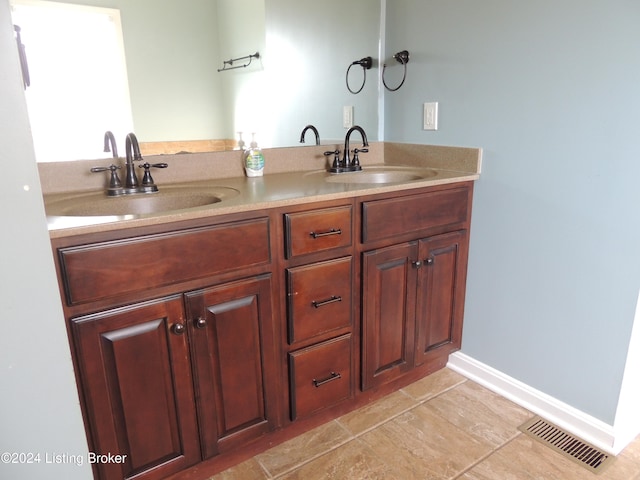 bathroom with tile patterned floors and vanity