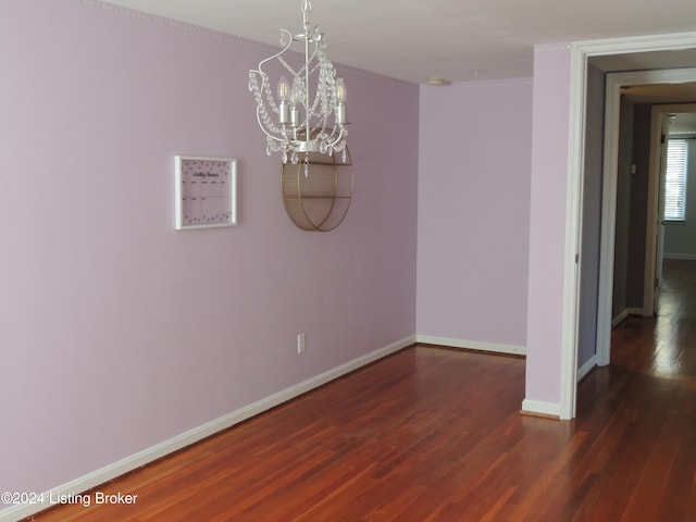 unfurnished dining area with crown molding and dark wood-type flooring