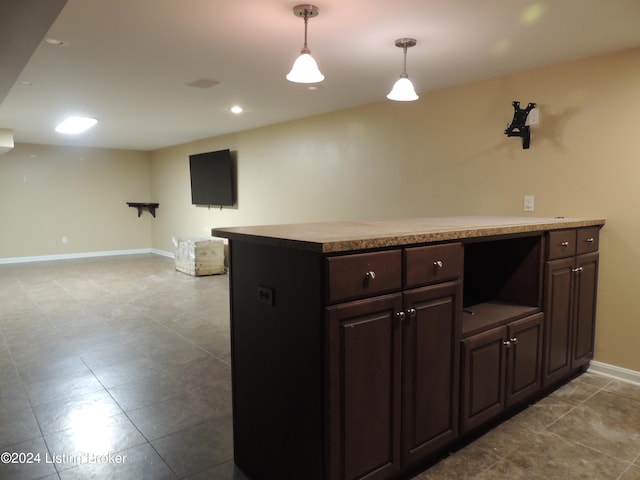 kitchen with decorative light fixtures and dark brown cabinetry