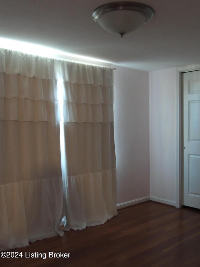 empty room featuring dark hardwood / wood-style flooring