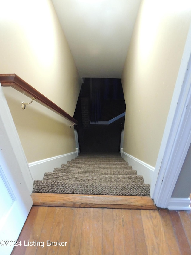 stairway with hardwood / wood-style flooring