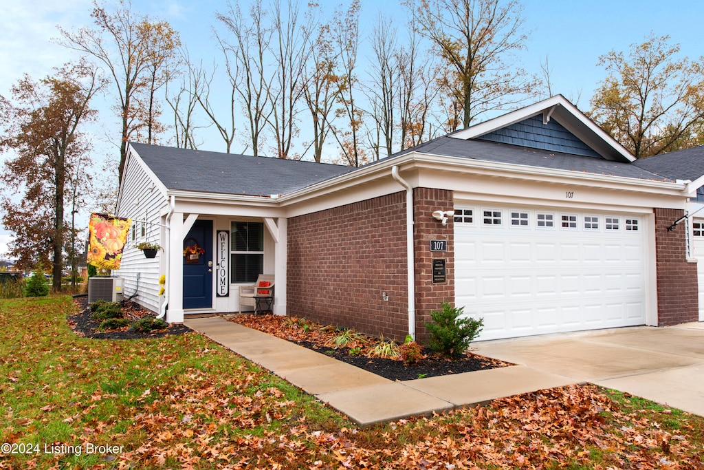 view of front facade with central air condition unit and a garage