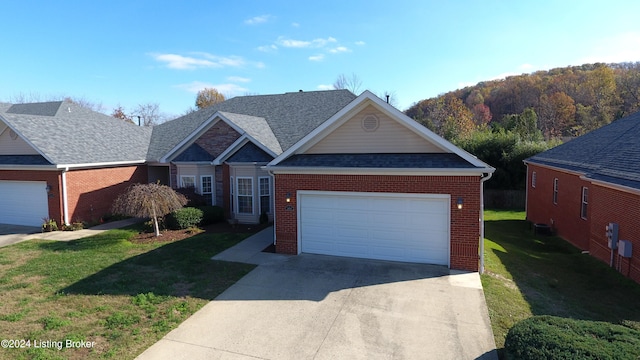 view of front of house with a garage and a front lawn