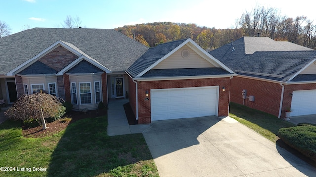 view of front of property featuring a garage and a front lawn