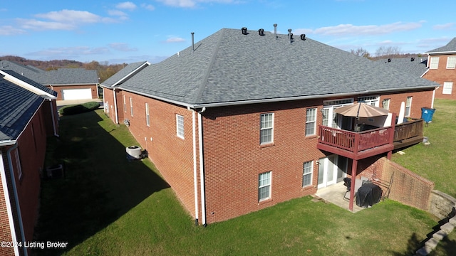 rear view of house with a yard, a deck, and a patio