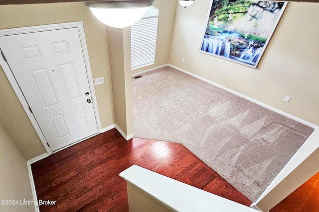 foyer entrance with dark hardwood / wood-style floors