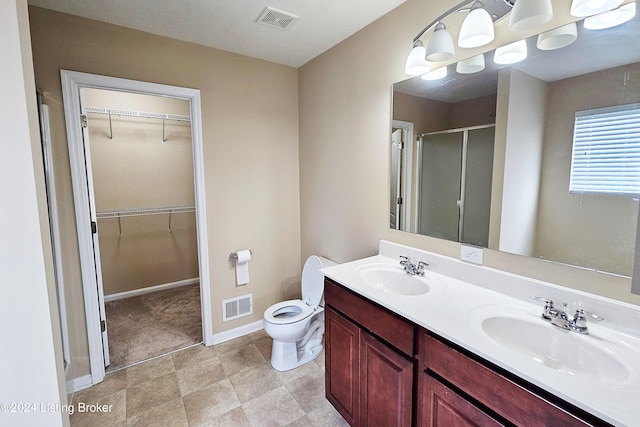 bathroom featuring vanity, toilet, and walk in shower