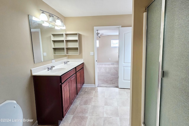 bathroom with vanity, ceiling fan, and a shower with door