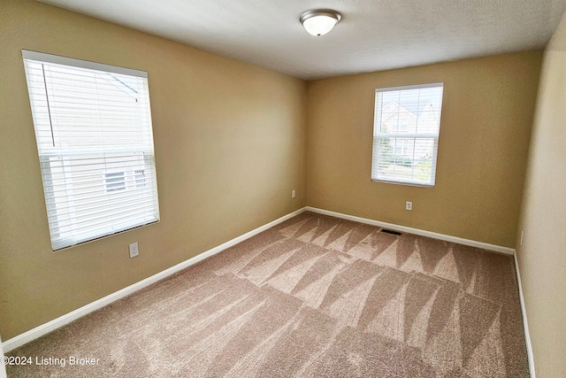 unfurnished room featuring carpet