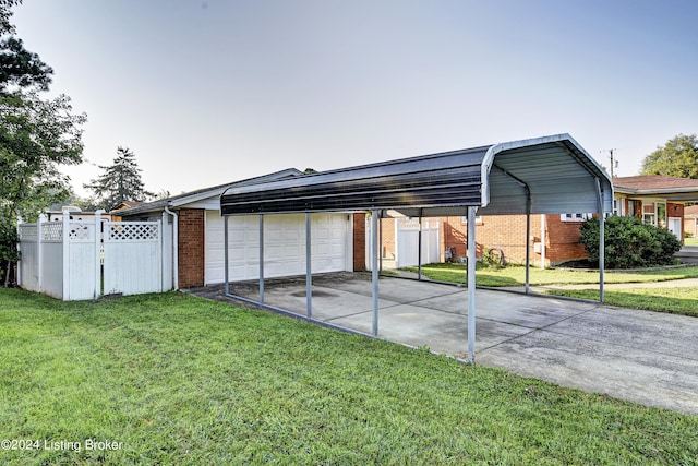 view of parking / parking lot featuring a garage, a carport, and a lawn