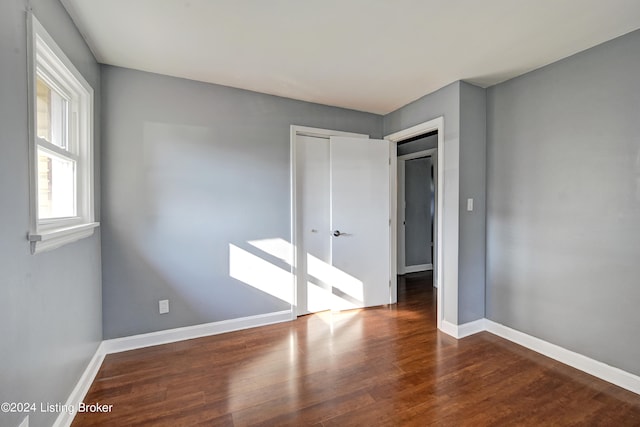 empty room with dark wood-type flooring