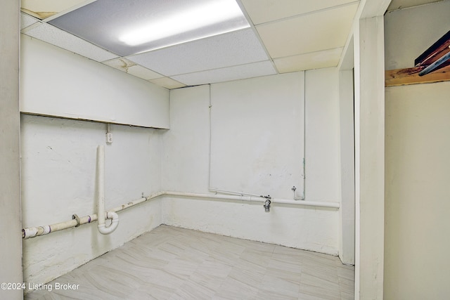 basement featuring a paneled ceiling